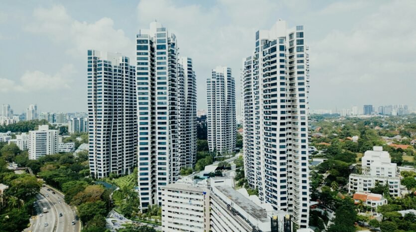 white high rise buildings under white clouds
